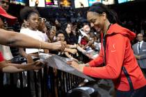 Las Vegas Aces forward A'ja Wilson signs autographs for fans after winning Game 2 in a first-ro ...