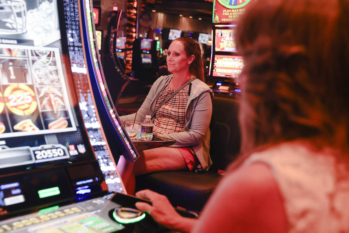 Pam Hillaker, right, of Idaho, plays the first Vegas NFL slot machine with her daughter Candice ...
