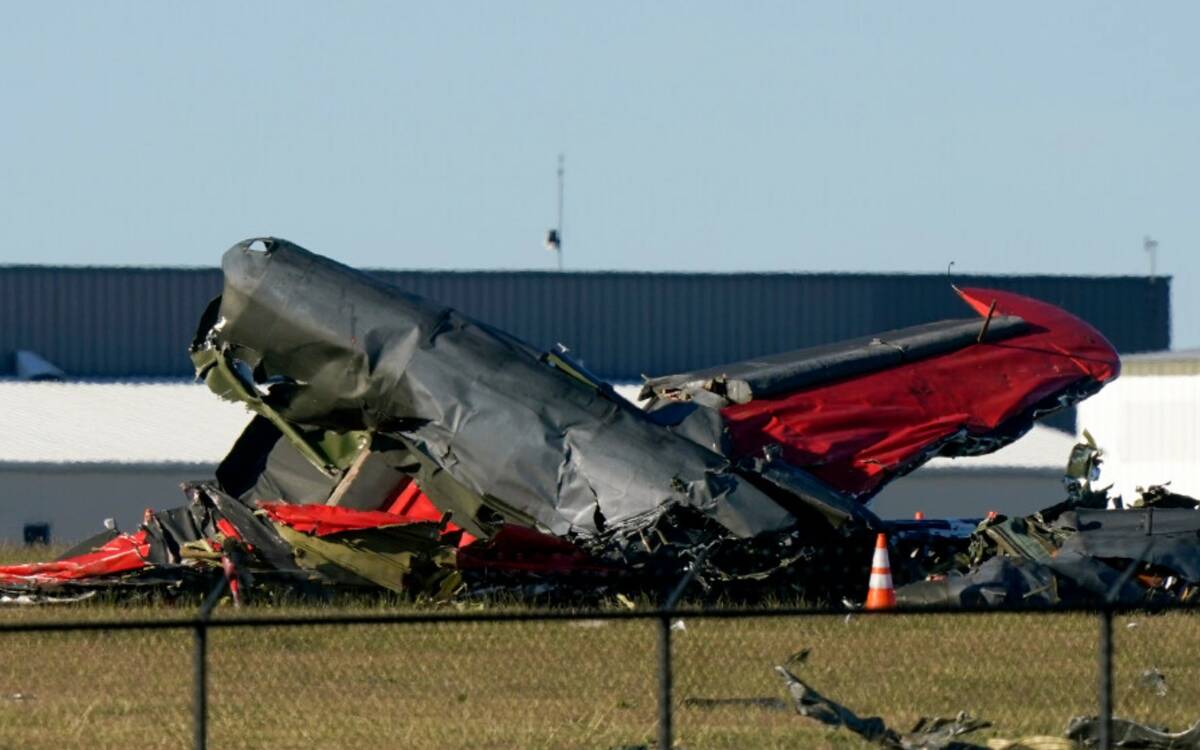 Debris from two planes that crashed during an airshow at Dallas Executive Airport are shown in ...
