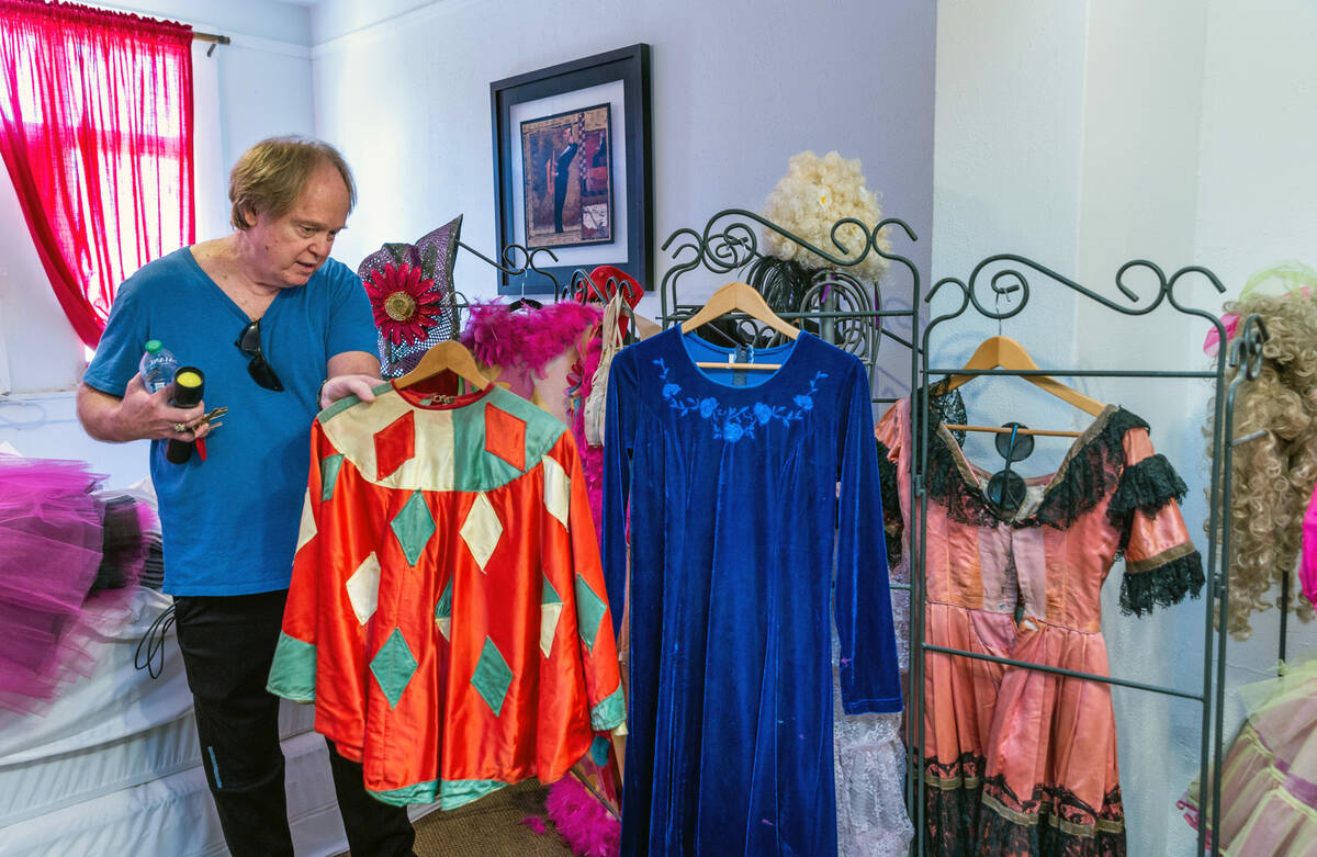 Fred Conboy looks at one of the handmade costumes from former owner and performer Maura Becket ...