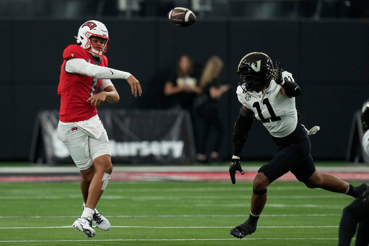 UNLV quarterback Jayden Maiava (1) throws against Vanderbilt defensive end Darren Agu (11) duri ...