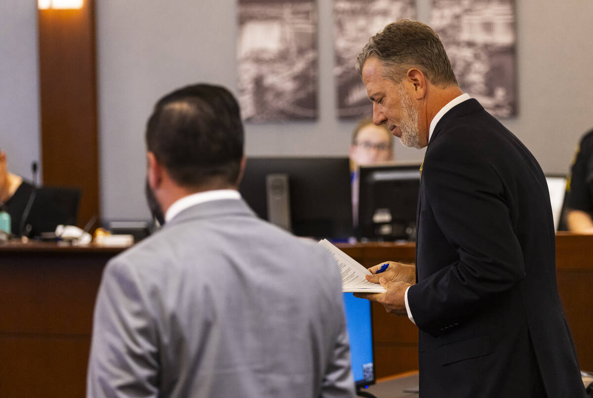 Bradley Schrager, an attorney for Clark County Education Association, right, looks at his notes ...