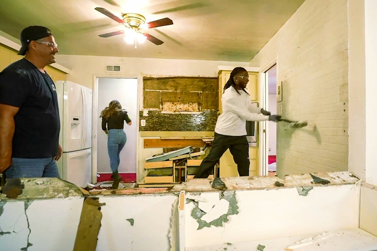 Raiders All-Pro wide receiver Davante Adams trades his football for a sledgehammer as he gifts ...