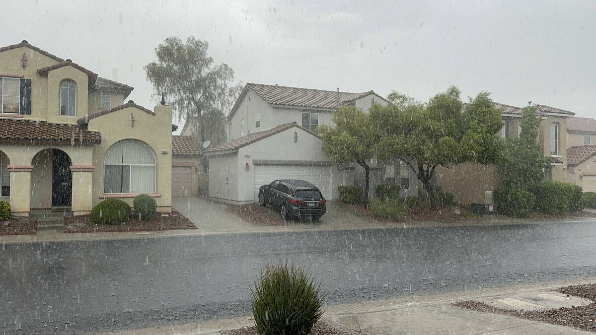 Rain washes down a residential street in Las Vegas on Wednesday, Sept. 20, 2023. (Brian Terstenyak)