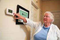Pamela Williams, a Sun City Anthem resident, resets the temperature in her home so to mitigate ...