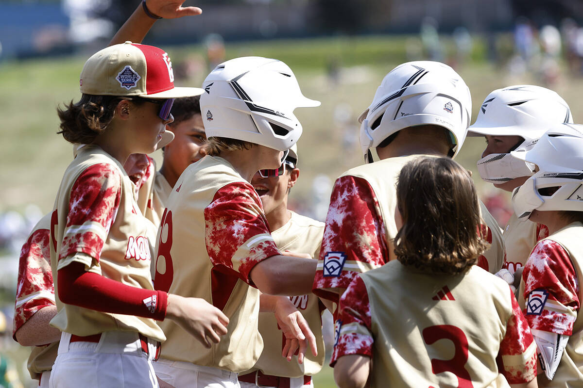 The Henderson All-Stars centerfield Nolan Gifford, center, celebrates with his teammates after ...