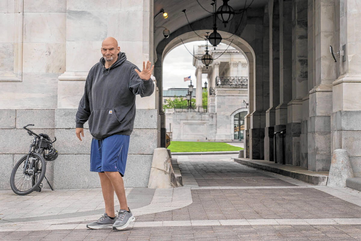 FILE - Sen. John Fetterman, D-Pa., waves to members of the media, Monday, April 17, 2023, on Ca ...