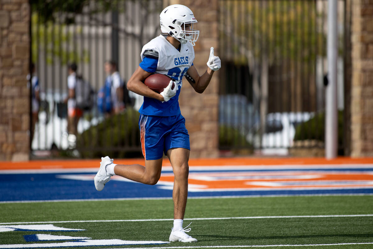 Bishop Gorman wide receiver Derek Meadows signals a successful play during football practice at ...