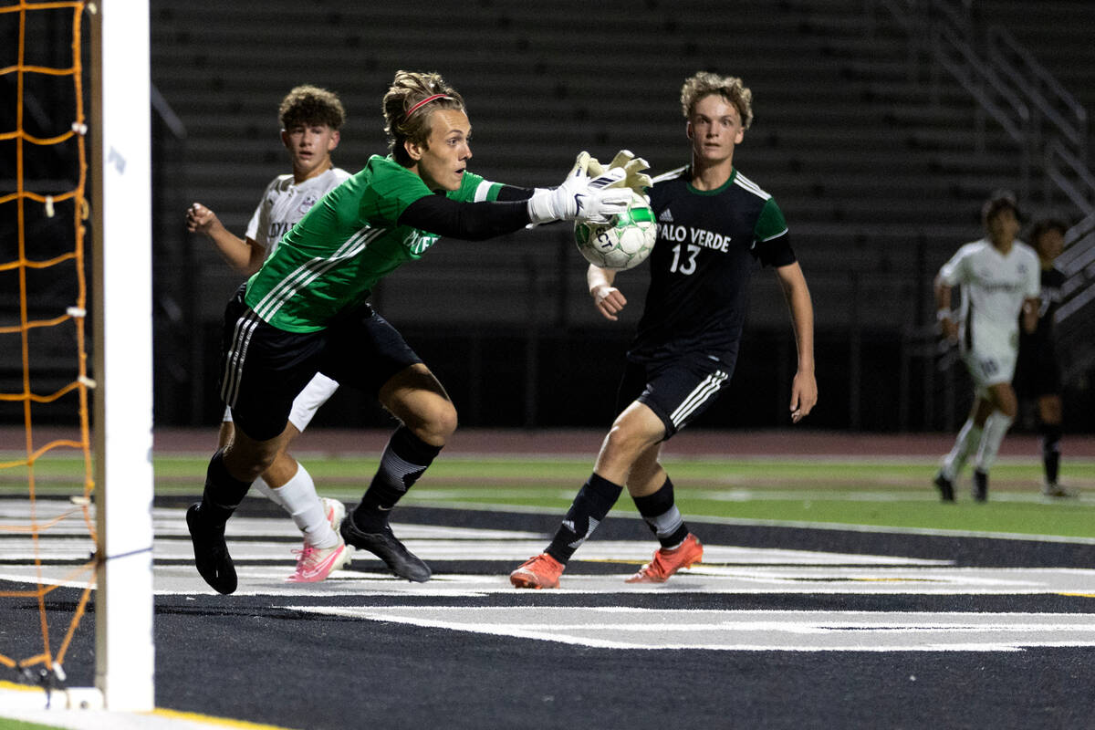 Palo Verde goalkeeper Henri Kettner saves the ball after Coronado’s Dylan Thomas, behind ...