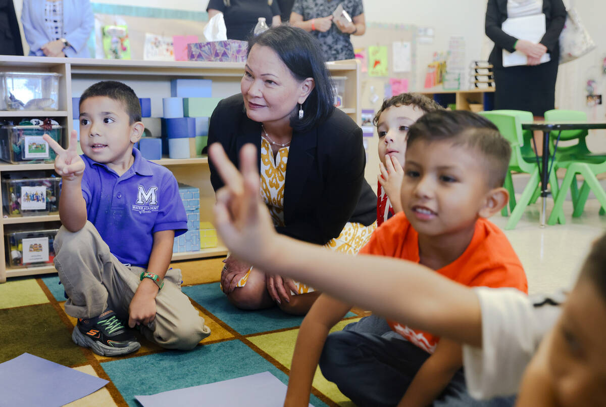 Eduardo Gonzalez, 4, from left, sits with Nevada Superintendent of Public Instruction Jhone Ebe ...