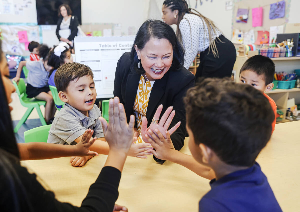 Nevada Superintendent of Public Instruction Jhone Ebert high-fives children during a pre-K less ...