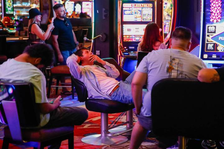 Impatient guests playing on slot machines at New York-New York Hotel and Casino wait for employ ...