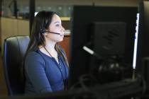 Call taker Natasha Austin answers calls at Metro’s dispatch center in Las Vegas, Wednesd ...