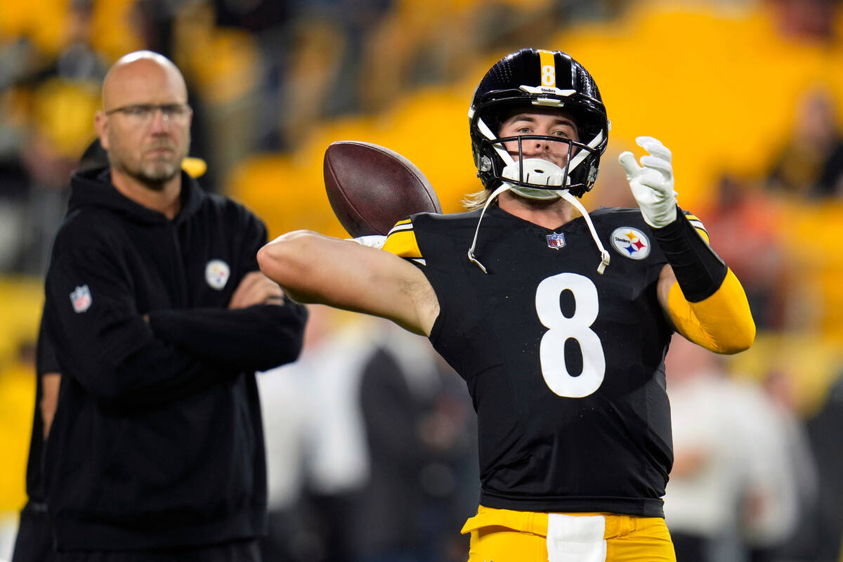 Pittsburgh Steelers quarterback Kenny Pickett (8) is watched by offensive coordinator Matt Cana ...