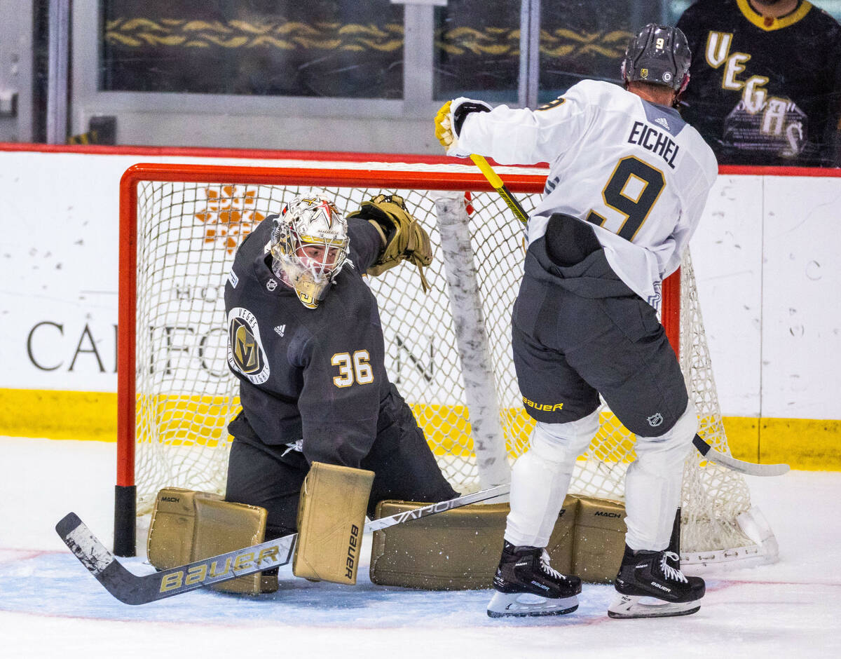 Golden Knights goalie Logan Thompson (36) looks to a shot by center Jack Eichel (9) during thei ...
