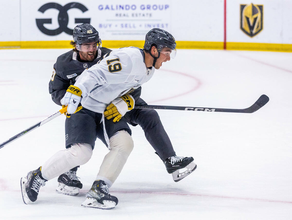 Golden Knights defenseman Lukas Cormier grabs center Brendan Brisson (19) as he heads for the n ...