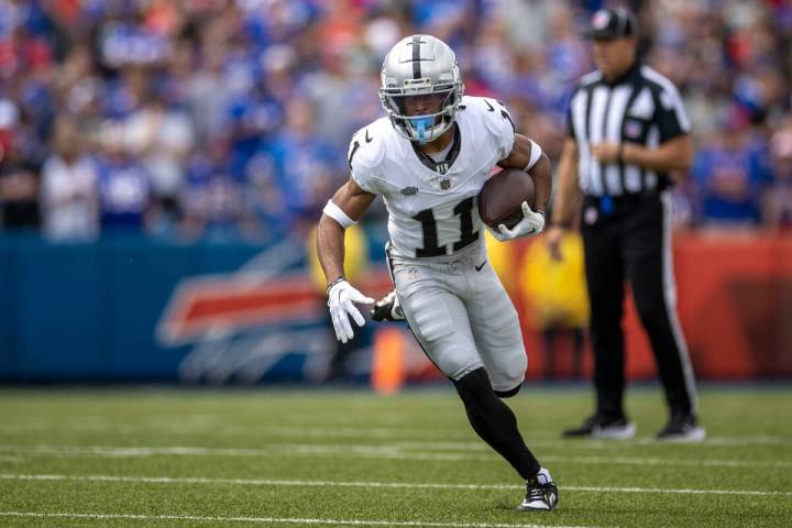 Raiders wide receiver Tre Tucker (11) runs with the football during the first half of an NFL ga ...