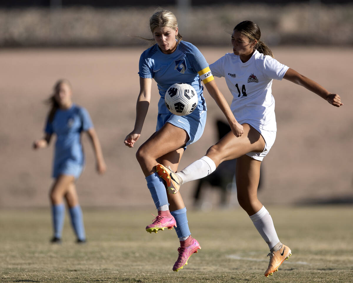 Foothill midfielder Tianna Hunsaker, center, bumps the ball forward while Doral center Peyton H ...