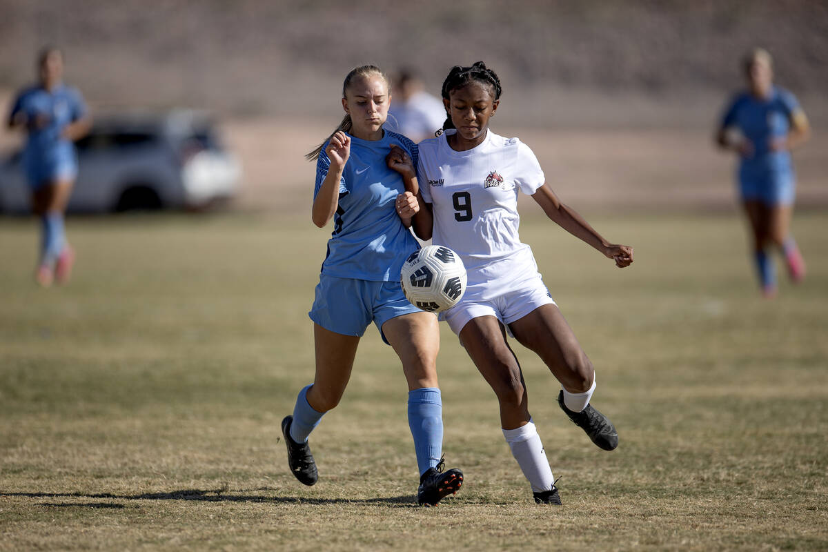 Foothill defender Natalia Hunsaker, left, competes for the ball with Doral forward Sanyi Thomps ...