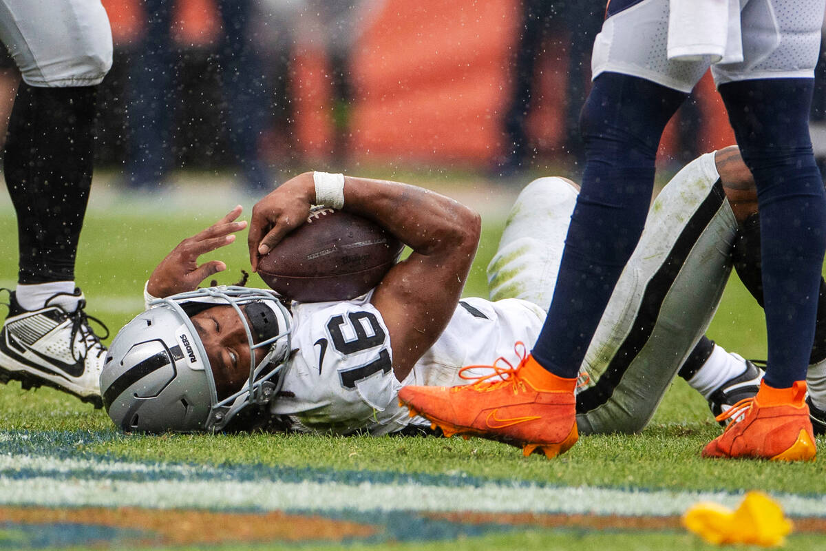 Raiders wide receiver Jakobi Meyers (16) holds onto the football after being concussed followin ...