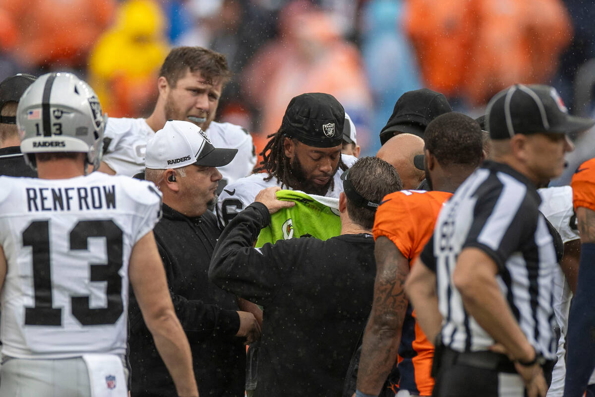 Raiders wide receiver Jakobi Meyers (16), center, stands surrounded by trainers after waking fr ...