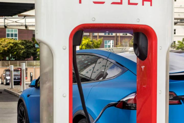 A car is plugged in at the Tesla Supercharger station near The LINQ and High Roller on Friday, ...