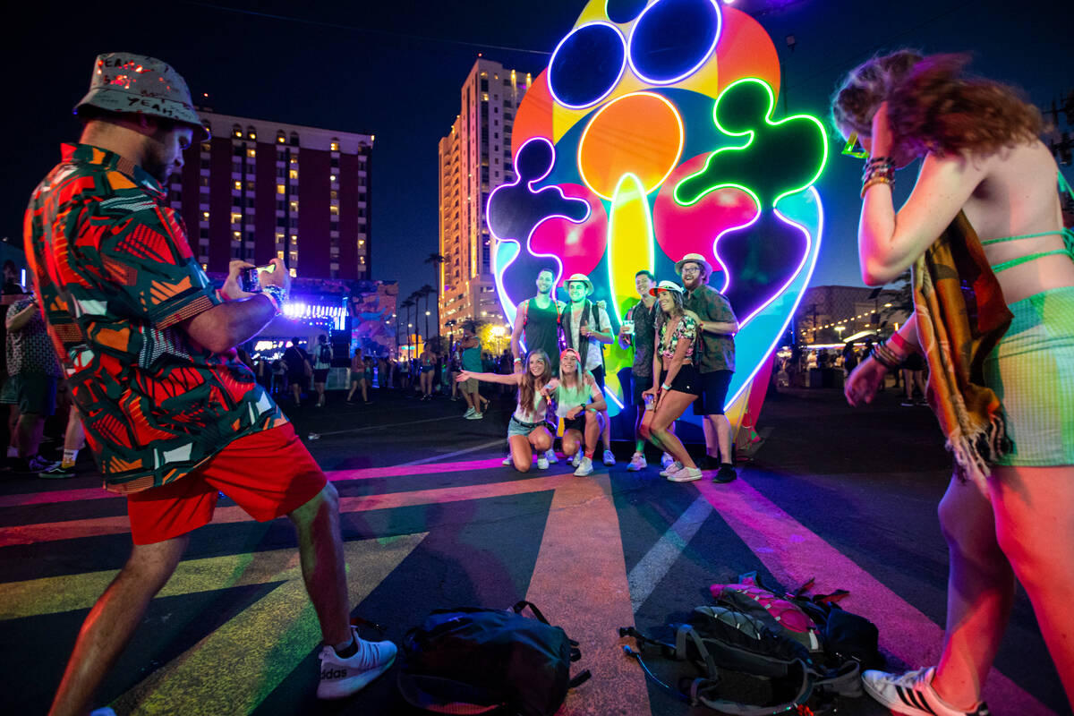 Attendees pose for pictures during the first day of the Life is Beautiful festival on Friday, S ...