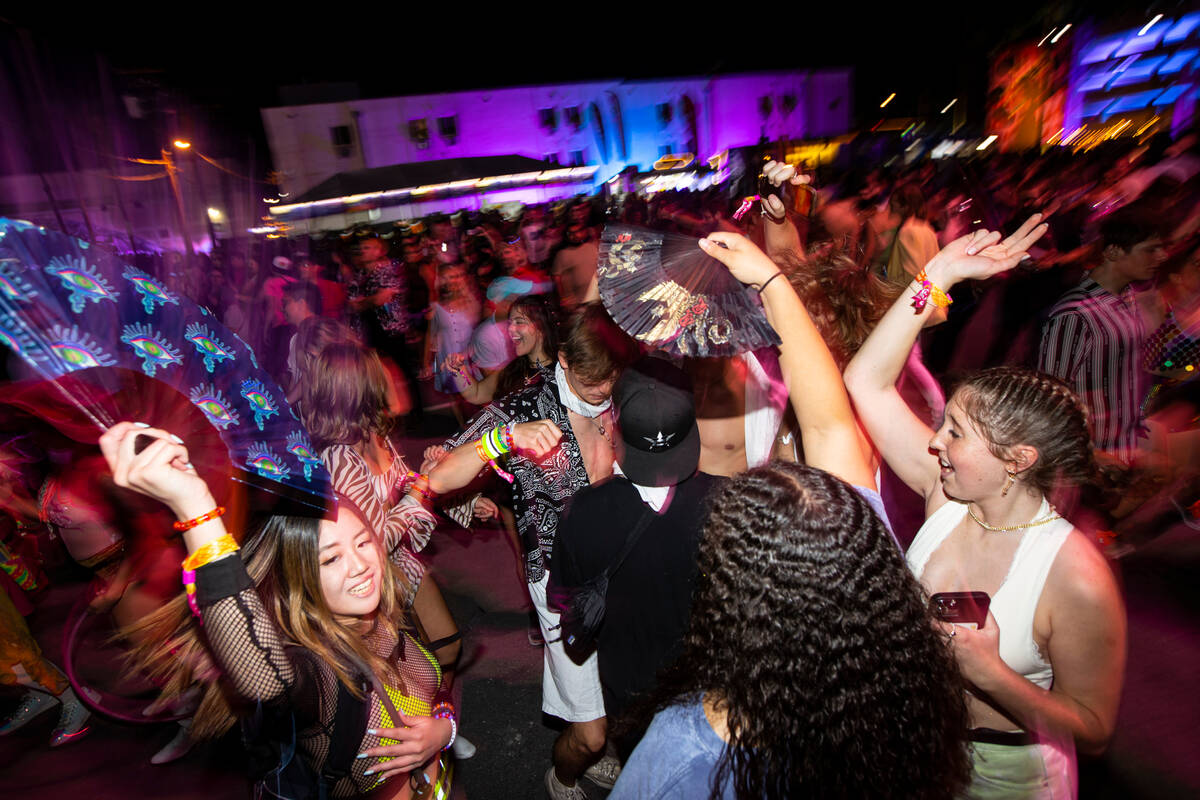 Attendees dance as Charli XCX, not pictured, performs during the first day of the Life is Beaut ...