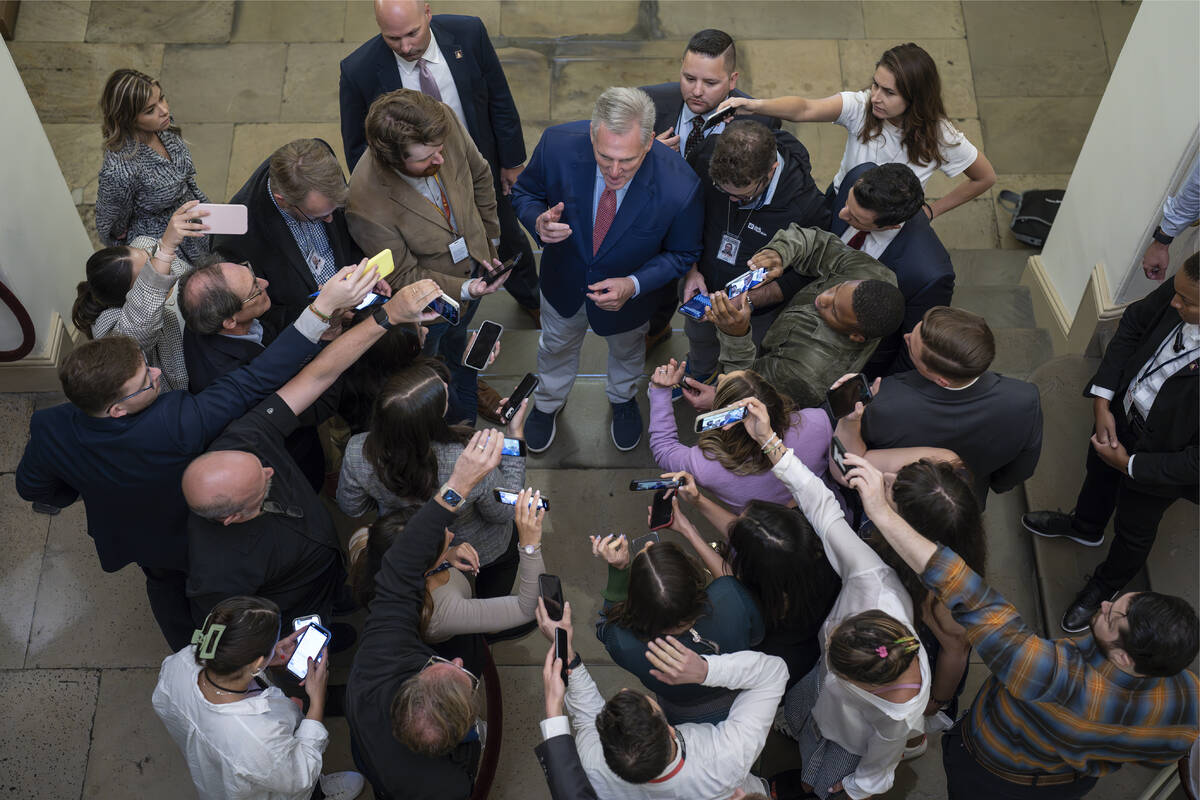 Speaker of the House Kevin McCarthy, R-Calif., is surrounded by reporters looking for updates o ...