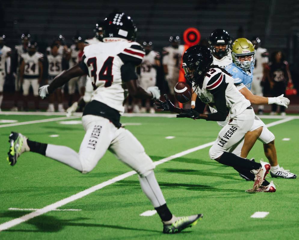 Las Vegas free safety Keisean Ellzy (13) intercepts the ball from a pass to Foothill wide recei ...