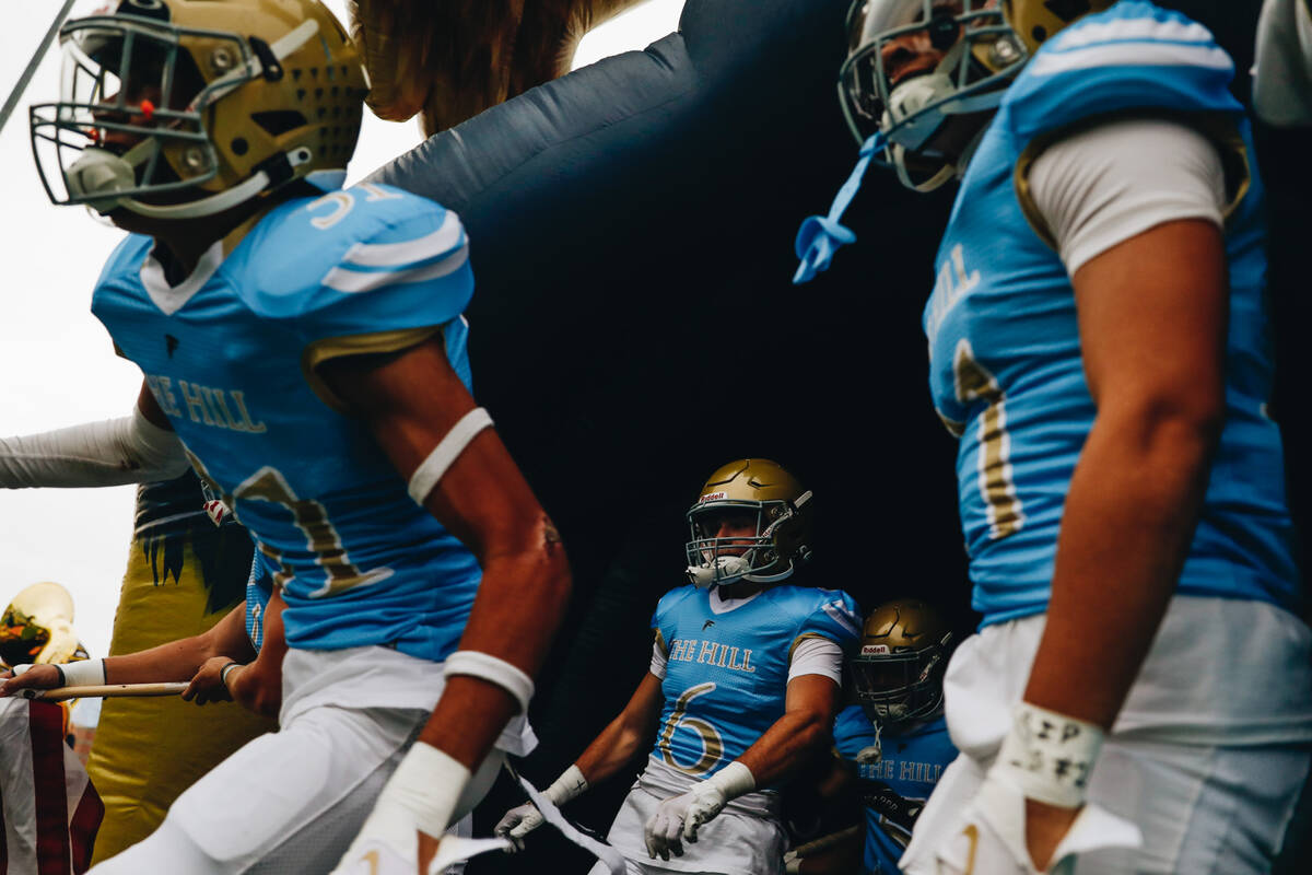 Foothill football players run onto the field before taking on Las Vegas High School in a footba ...