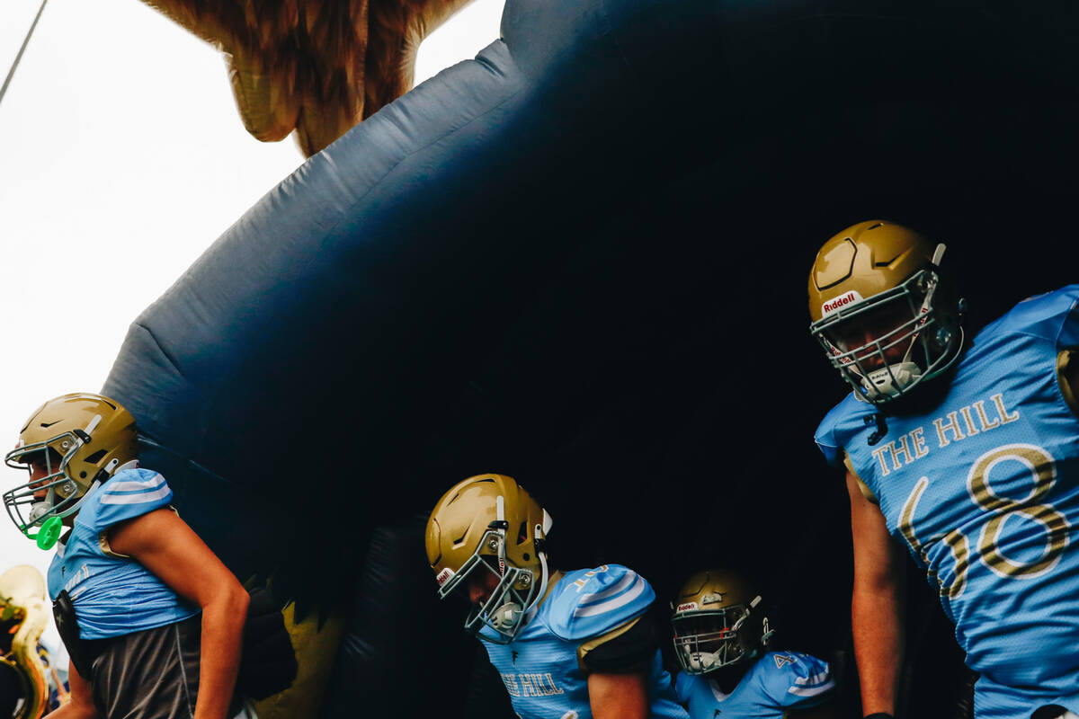 Foothill football players run onto the field before taking on Las Vegas High School in a footba ...
