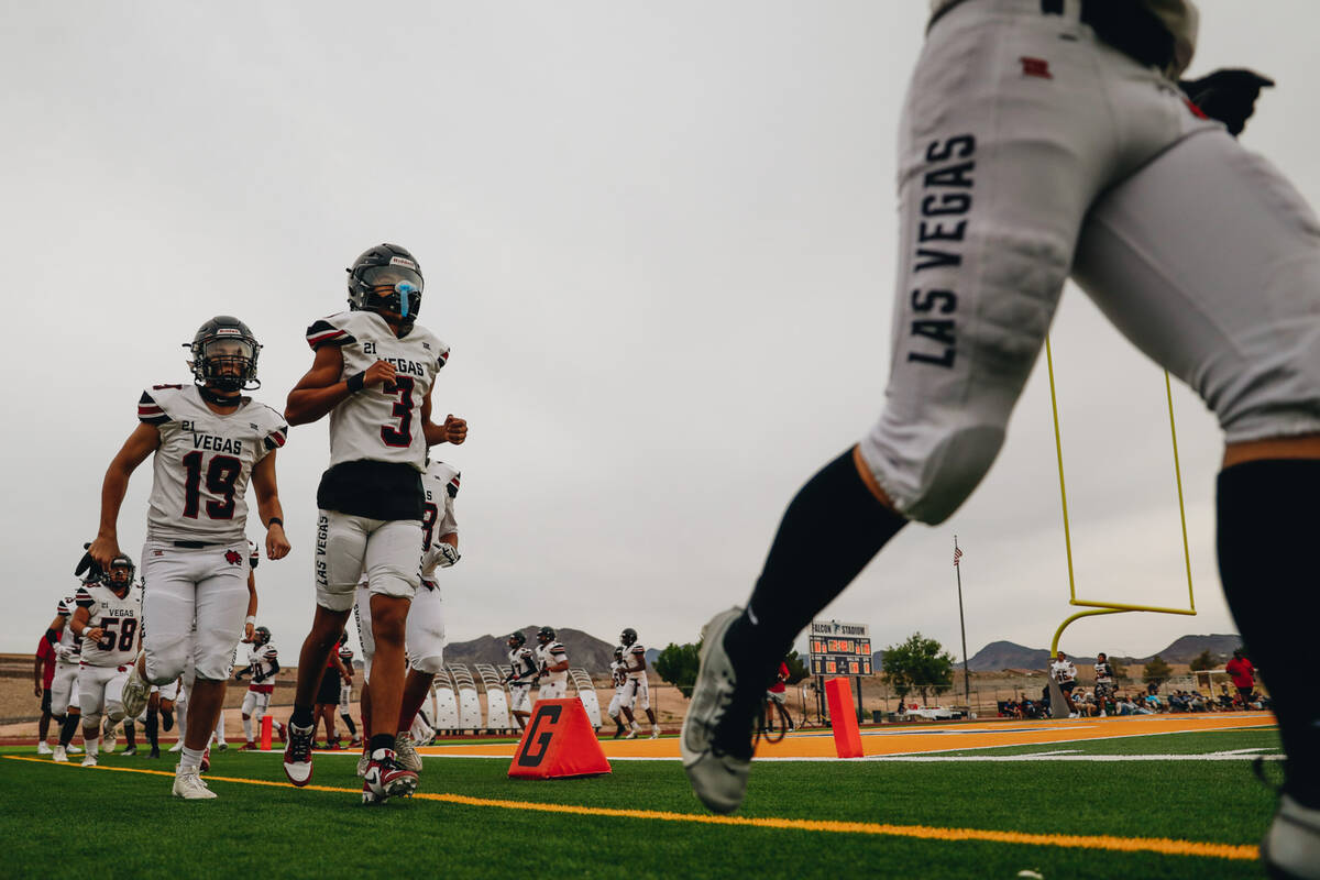Las Vegas High School football players run onto the field before taking on Foothill in a game a ...