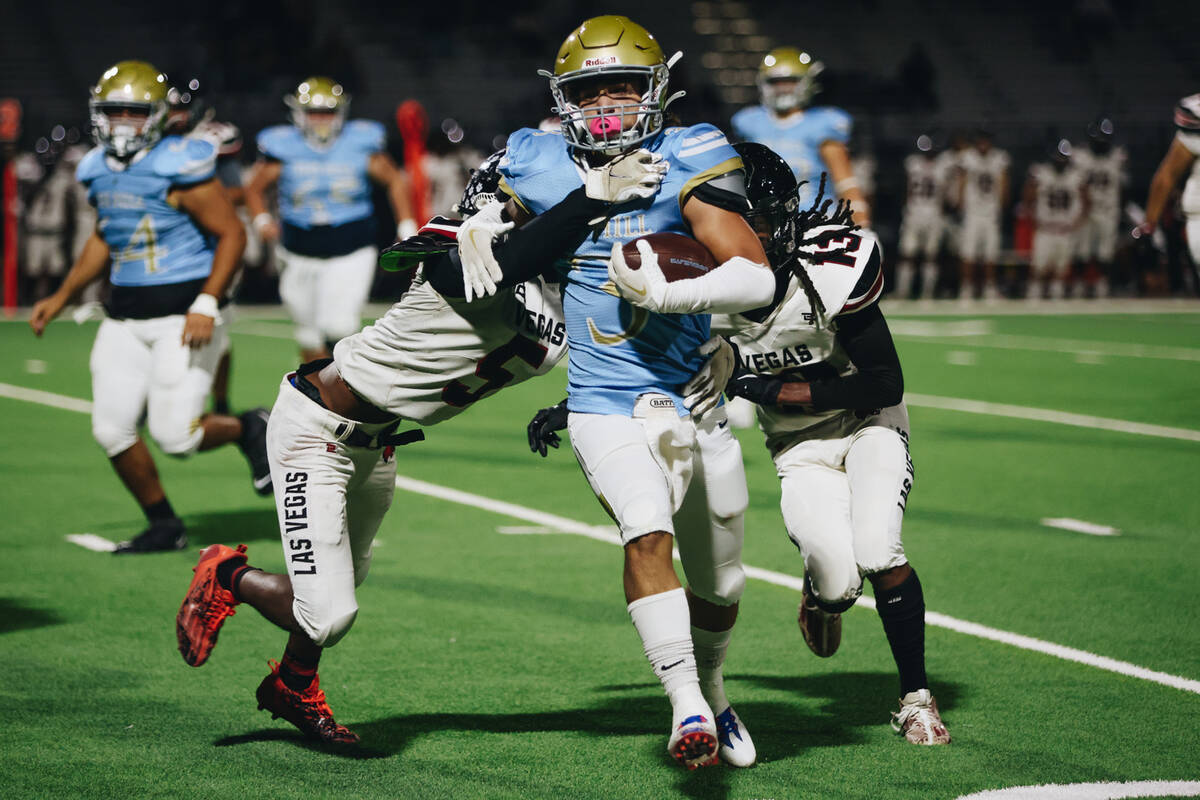 Foothill running back Eugene Altobella III (3) tries to free himself from Las Vegas defensive p ...