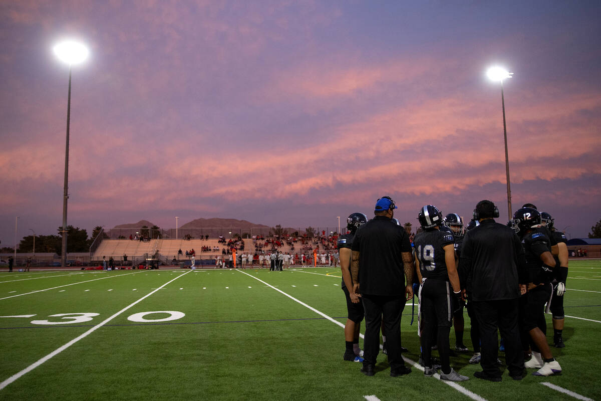 Desert Pines strategizes during the first half of a high school football game against Arbor Vie ...