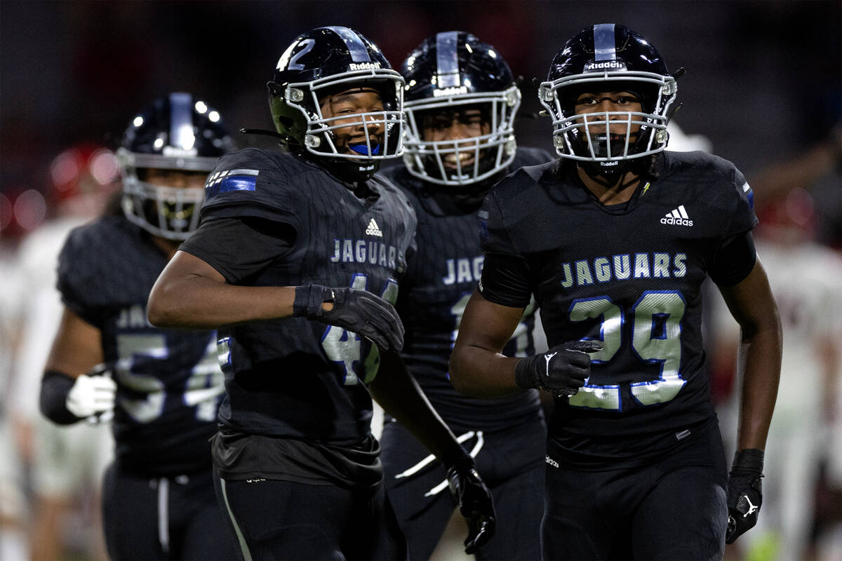 Desert Pines defensive end Zeshawn Martin (42) happily heads to the bench with teammates includ ...
