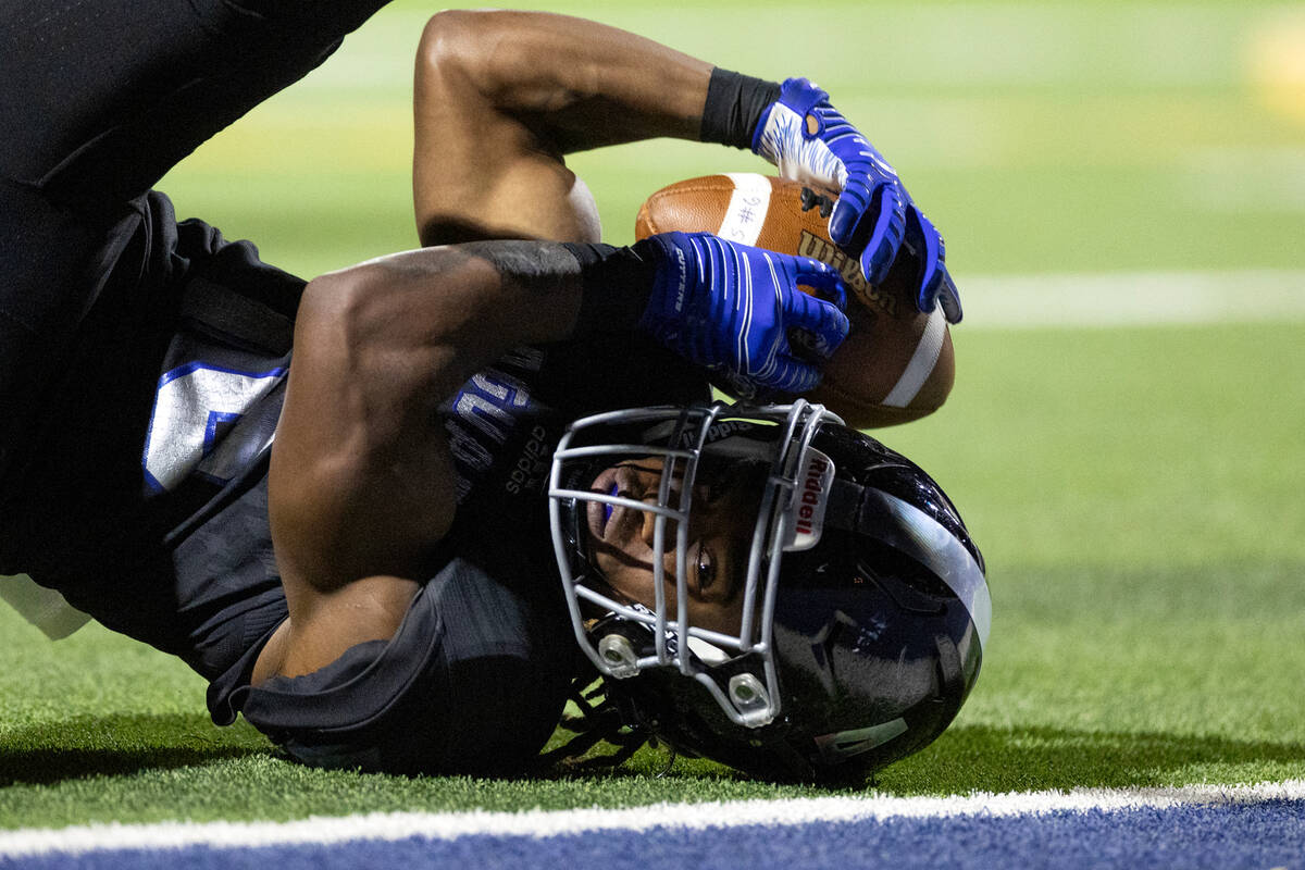 Desert Pines’ Quinten Larry (16) goes down with the ball but barely misses the end zone ...