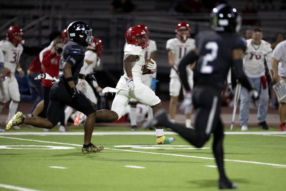 Arbor View running back Kamareion Bell (20) takes the ball up the field followed by Desert Pine ...
