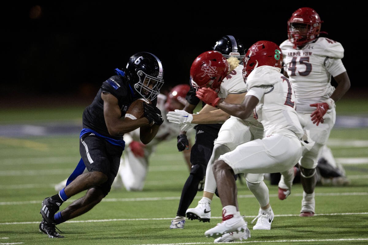 Desert Pines wide receiver Massiah Mingo (6) braces for a tackle by Arbor View during the secon ...