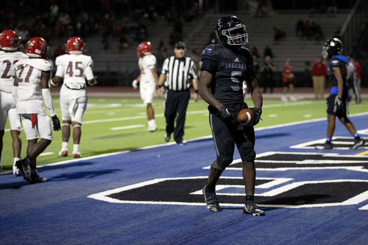 Desert Pines running back Greg Burrell (5) celebrates his touchdown during overtime in a high s ...