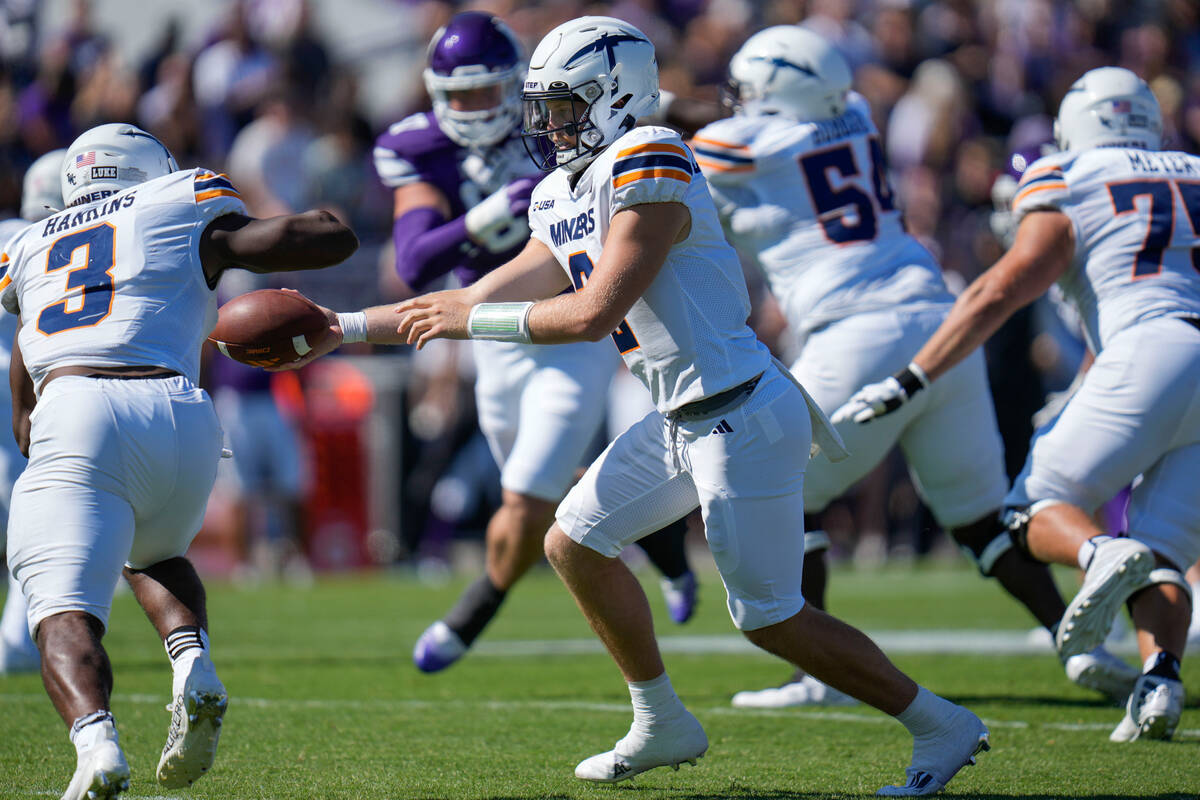 UTEP quarterback Gavin Hardison, front right, hands off the ball to running back Deion Hankins ...