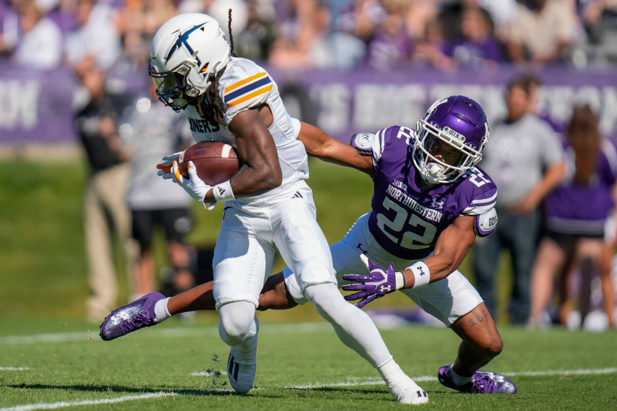 UTEP wide receiver Tyrin Smith, left, avoids a tackle by Northwestern defensive back Evan Smith ...