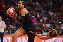 Las Vegas Aces forward A'ja Wilson (22) moves past Washington Mystics forward Tianna Hawkins (2 ...