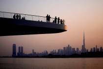 People stand on the observation deck of the Dubai Creek Harbour in Dubai, United Arab Emirates, ...