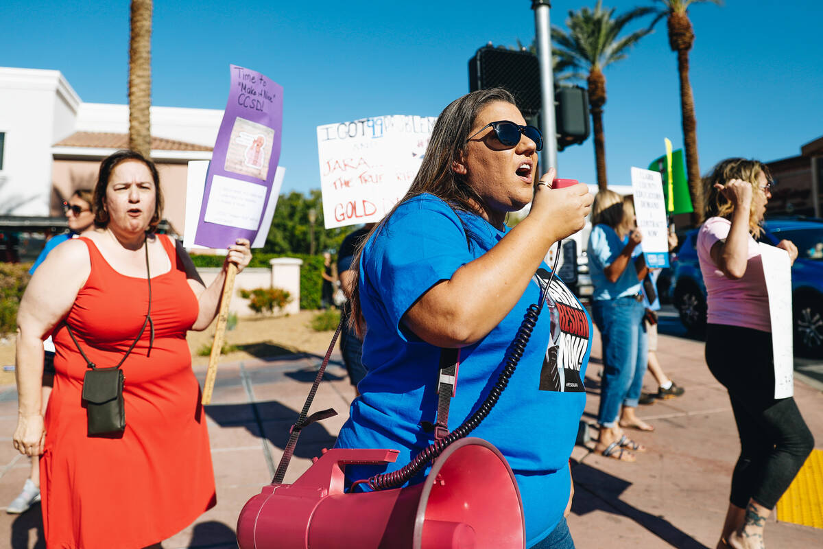 Jacqueline Davania-Williamson, middle, uses a speaker to protest in support of the Clark county ...