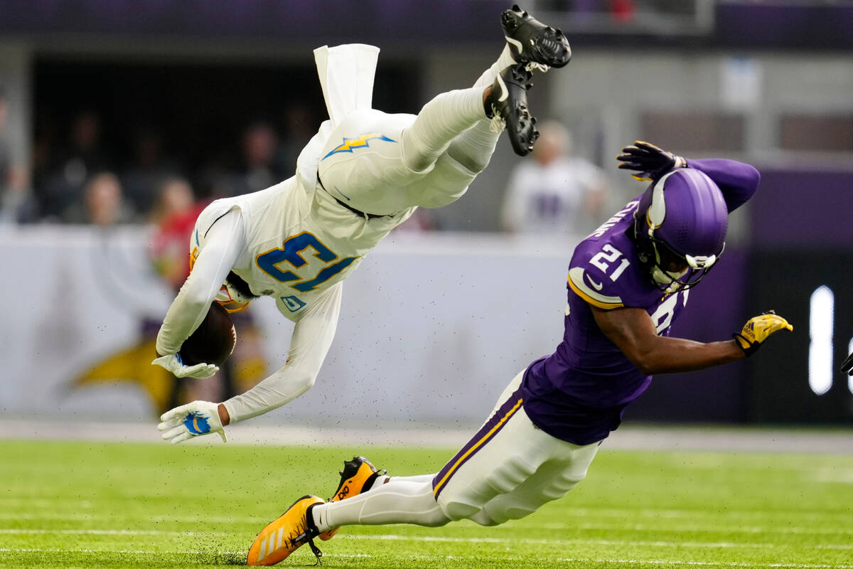 Los Angeles Chargers wide receiver Keenan Allen (13) is tackled by Minnesota Vikings cornerback ...