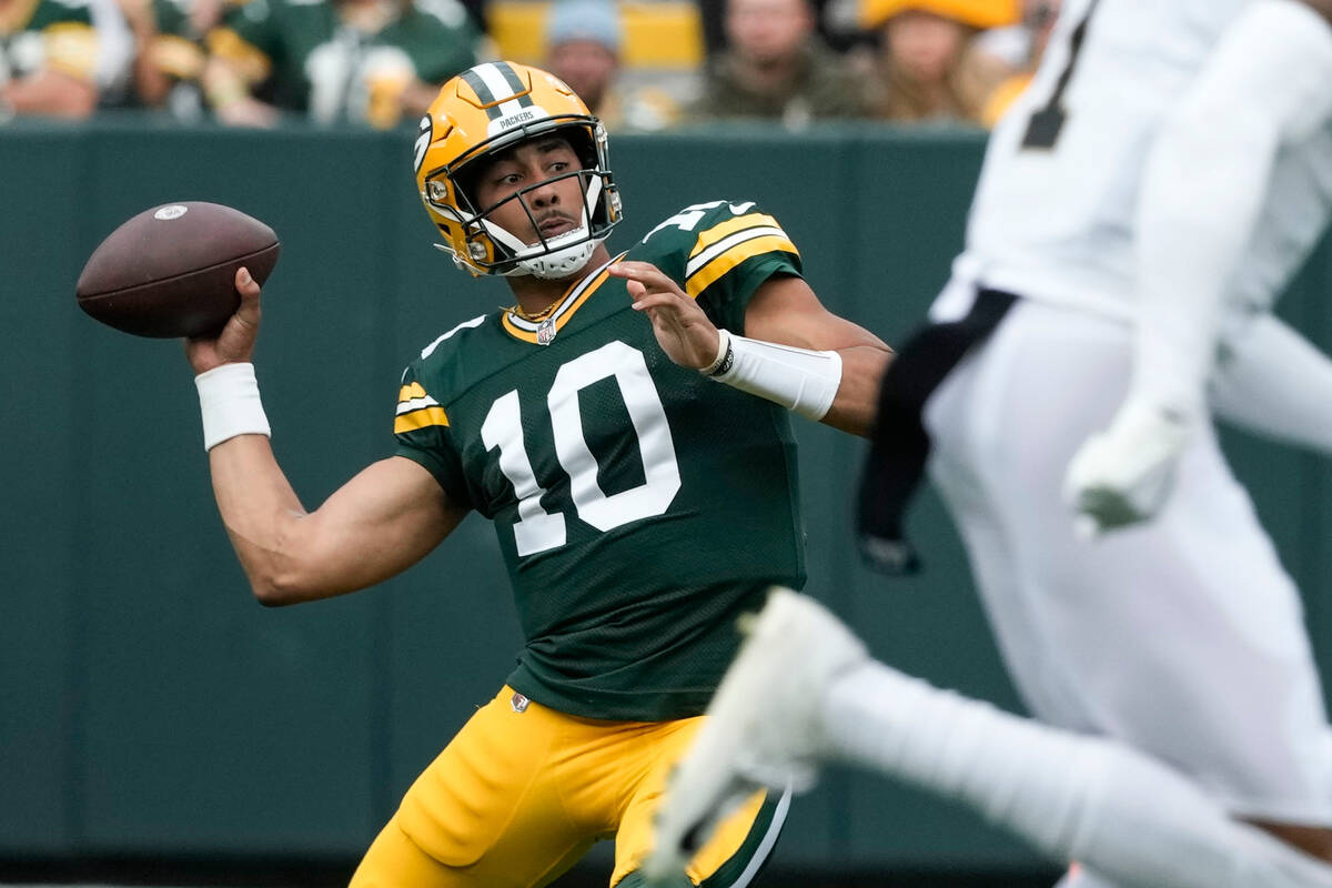 Green Bay Packers quarterback Jordan Love (10) slips as he throws on fourth down during the fir ...