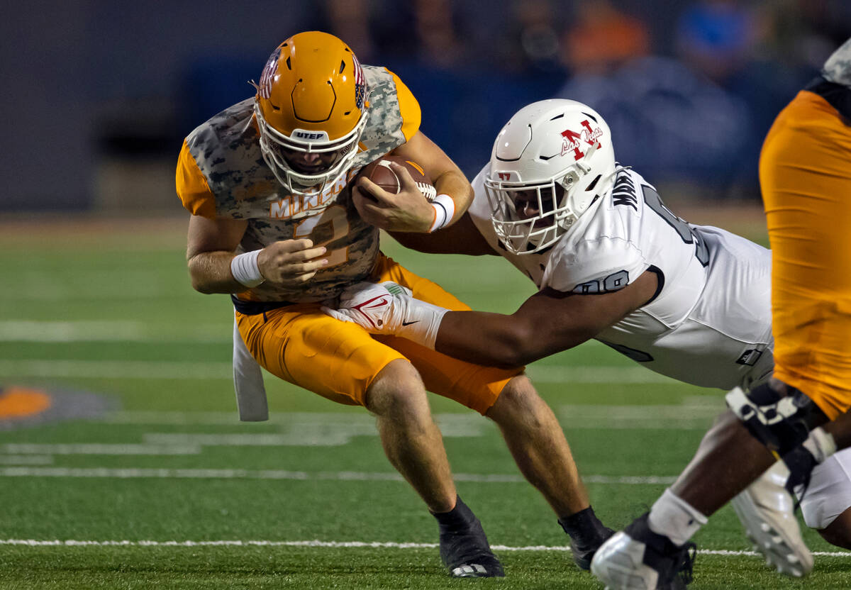 UNLV defensive lineman Tatuo Matinson, right, sacks UTEP quarterback Gavin Hardison during the ...