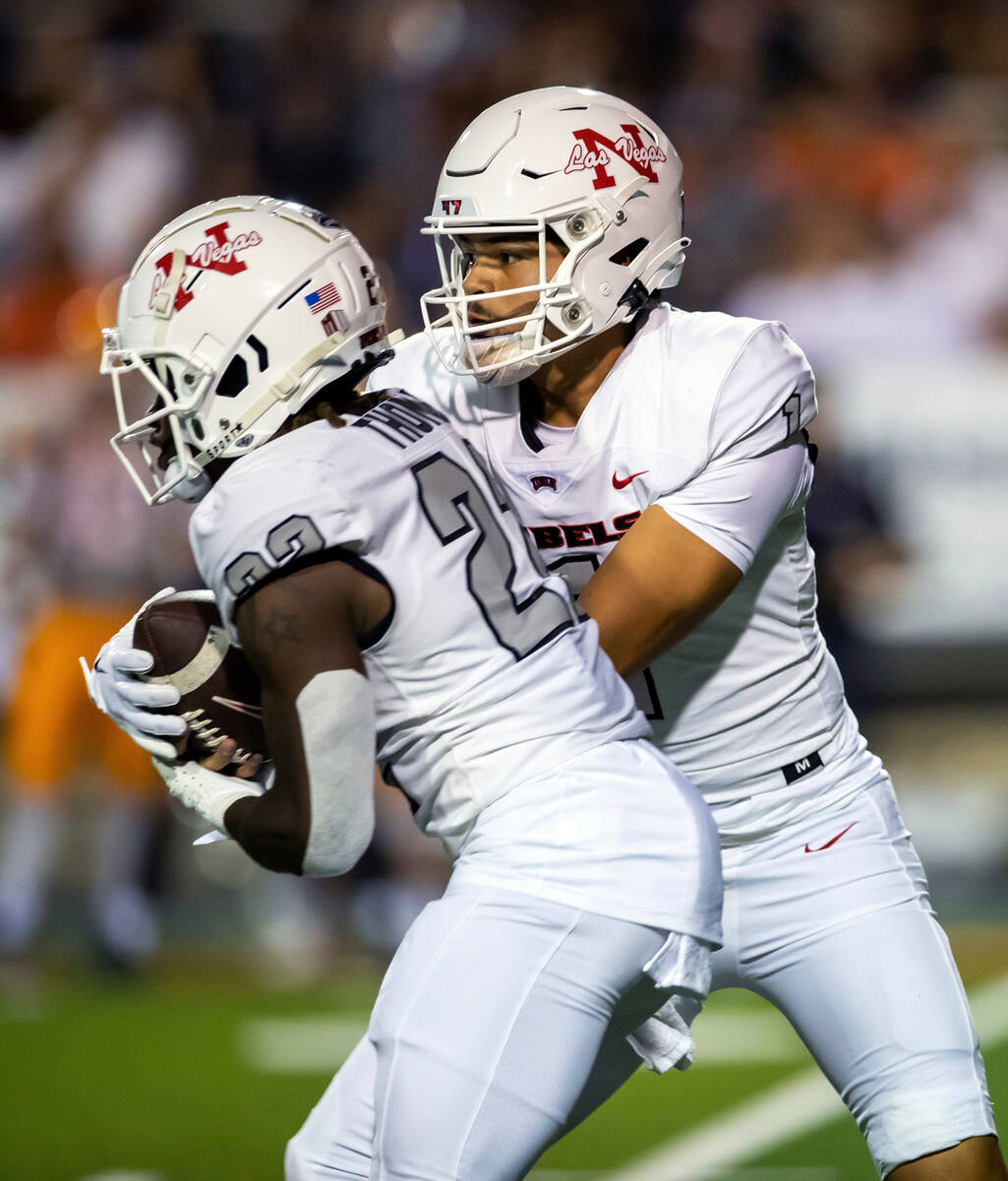 UNLV quarterback Jayden Maiava, right, hands the ball off to running back Jai'Den Thomas during ...