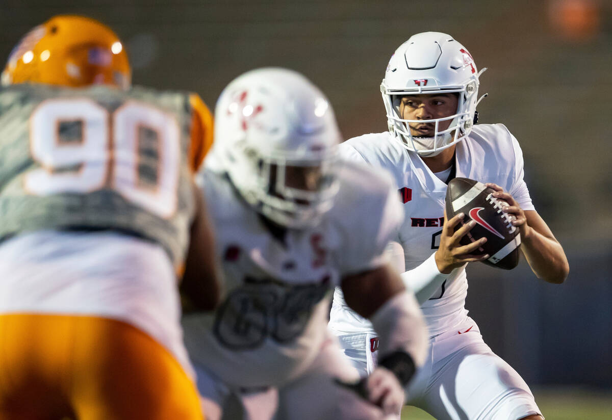 UNLV quarterback Jayden Maiava, right, looks to throw a pass during an NCAA college football ga ...